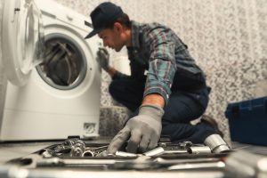 choosing-the-right-tool-plumber-repairing-washing-machine-picture-id1170038003 (1)